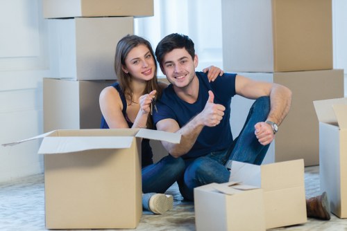 Professional movers handling boxed stock and office items for a commercial relocation
